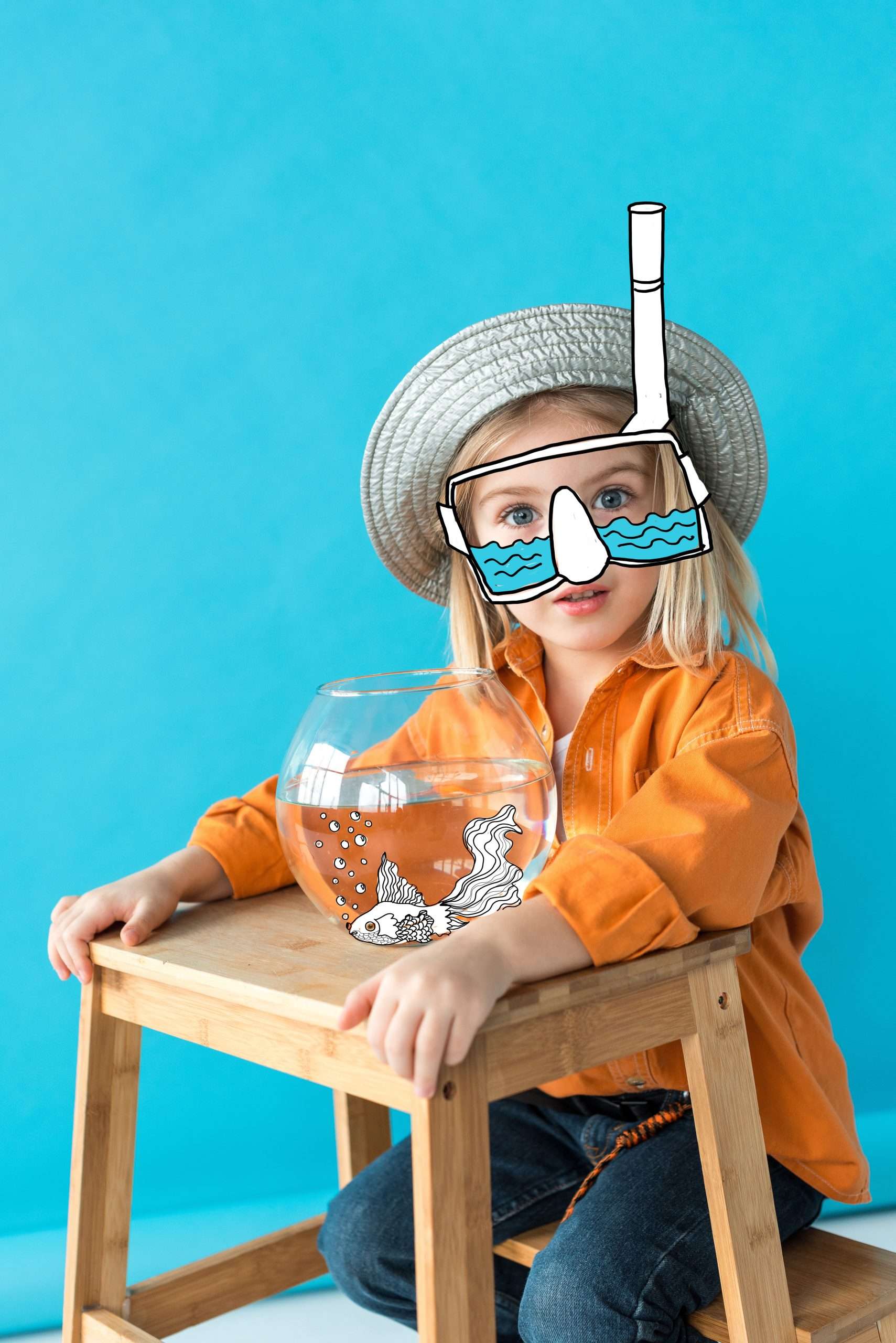 kid in silver hat, orange shirt and snorkel sitting on stairs with fairy fish in aquarium on blue background
